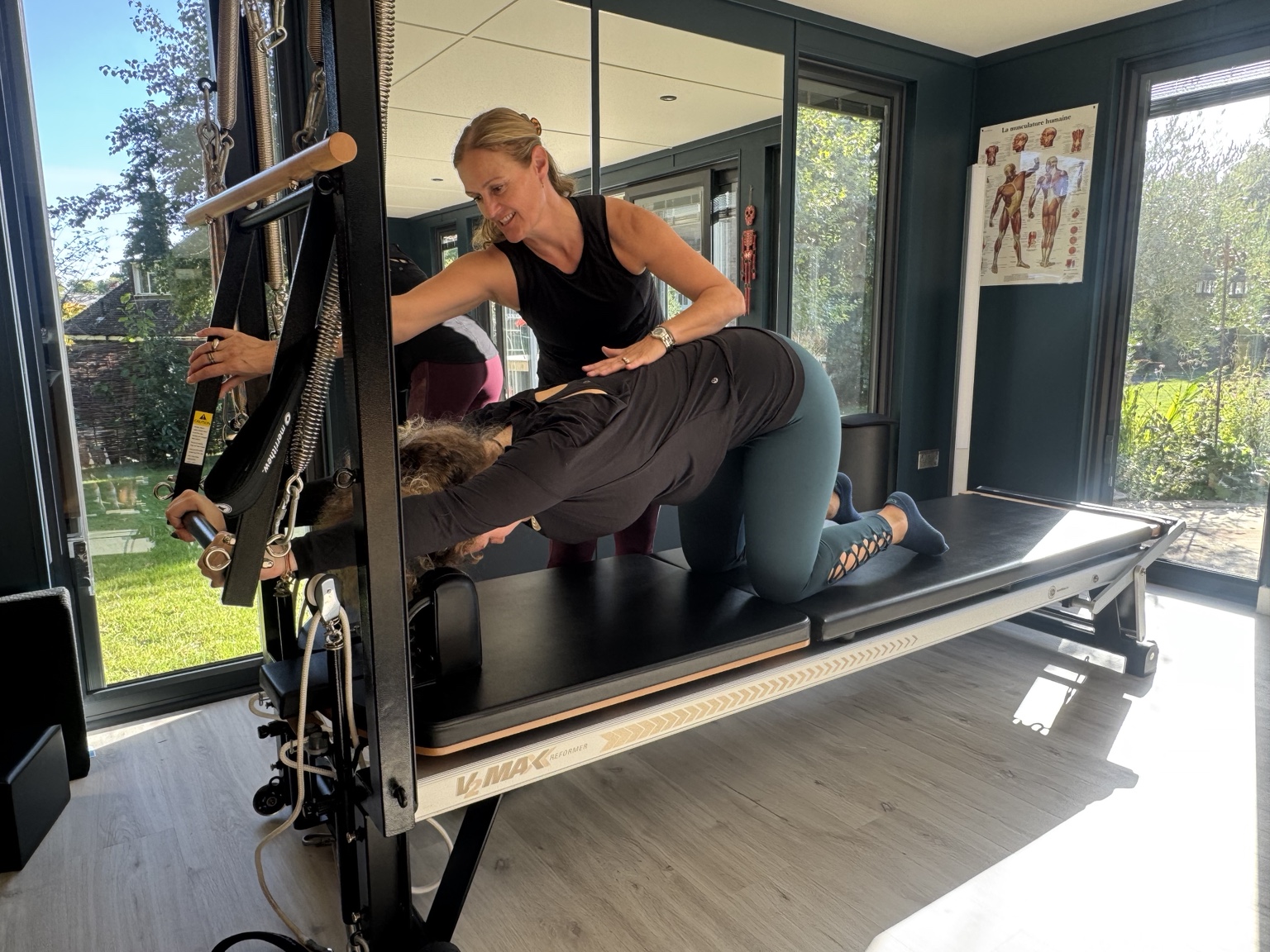 Murielle Pickard-Dellis providing hands-on instruction during Reformer training
